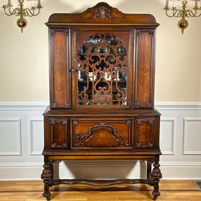 ANTIQUE CHINA CABINET | Having carved wood front with glass door over carved wood cabinet with spindle carved and fluted legs. - h. 73.5...