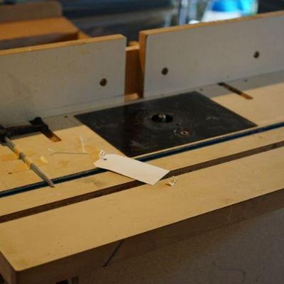 adjustable router with a table hand built by the owner that fits  the router and the router also come out. very nice. built in outlet etc. 
