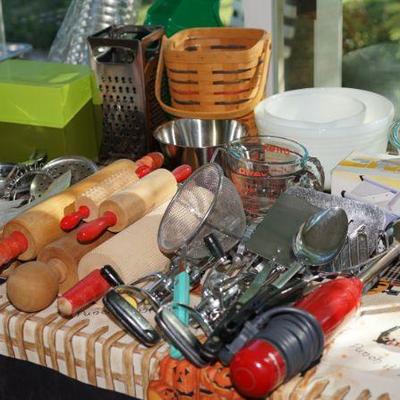 Tables of kitchen bakeware, collectibles, Longaberger baskets, casseroles including corning ware cornflower and other. 