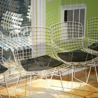 Harry Bertoia for Knoll style chairs with black leather pads