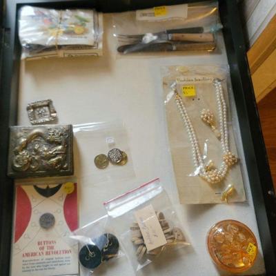 Buttons, jewelry boxes, a glass frog, old utensils