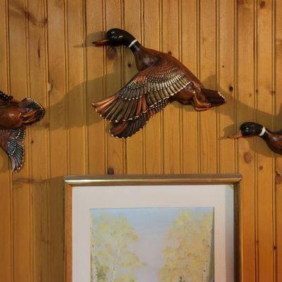 Three ducks on a wall
