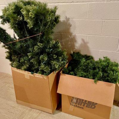 Artificial Christmas tree in one box and garlands in the other