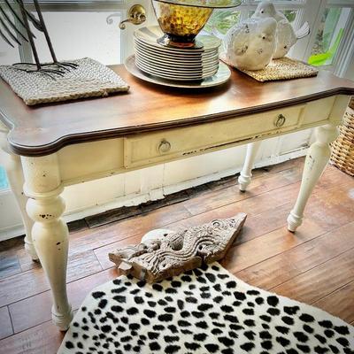 Faux cheetah rug and ivory console table