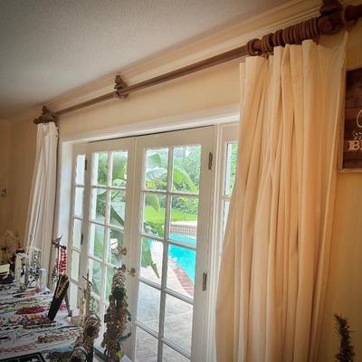 All window treatments are for sale, including rods, drapes, and blinds