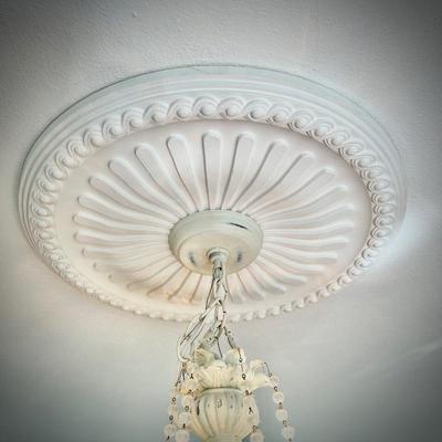 White chandelier located in bedroom