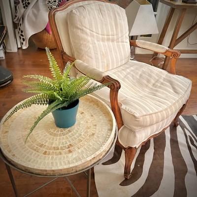 One of two vintage wood-frame ivory striped armchairs
