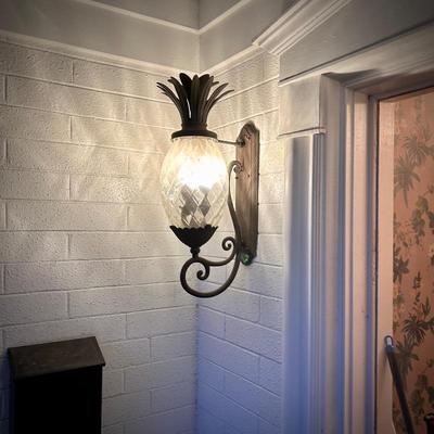 All light fixtures are for sale. This is the second of two pineapple outdoor wall lamps by the front door.