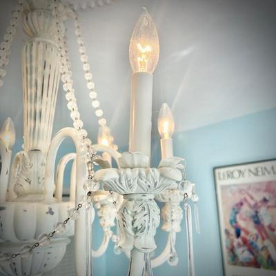White chandelier located in bedroom