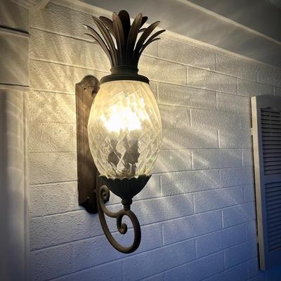 All light fixtures are for sale. This is the first of two pineapple outdoor wall lamps by the front door.