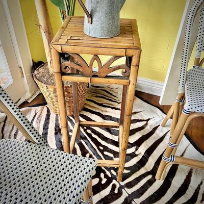 One of two rattan plant stands