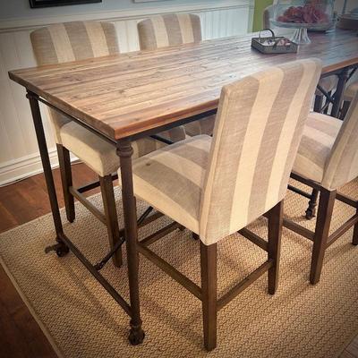 98" long bar-height dining table. Six chairs shown, but can seat 8-10. Chairs are bar-height, with gray and white striped upholstery.