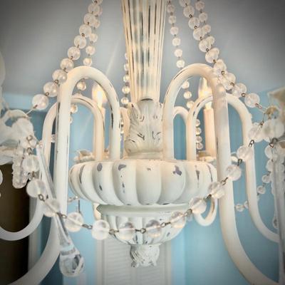 White chandelier located in bedroom
