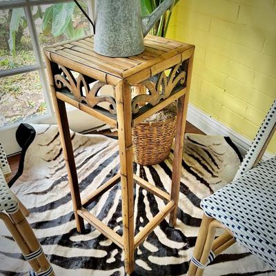 One of two rattan plant stands
