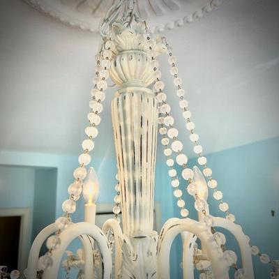 White chandelier located in bedroom