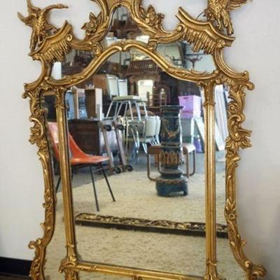 1181	FRIEDMAN BROTHERS GILTWOOD MIRROR WITH CARVED FLOWERS AND BIRD ON CREST, APPROXIMATELY 39 IN X 57 IN H, LOSS TO BIRD LEG & WING
