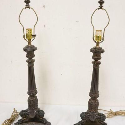1112	ORNATE CAST METAL TABLE LAMPS IN THE FORM OF FOOTED CANDLESTICKS, EACH APPROXIMATELY 31 IN H
