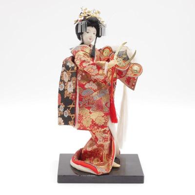 Geisha Doll Holding Samurai Helmet on Laquered Base