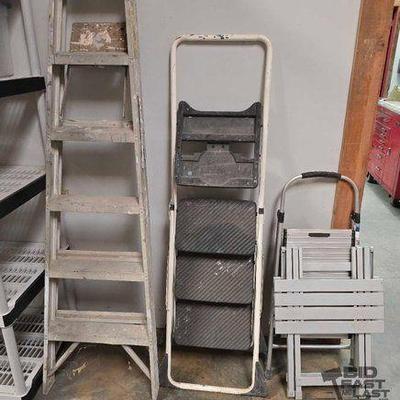 #2110 • (1) 6' A-Frame Ladder, (2) Cosco Step Ladders, and (1) Foldable Table