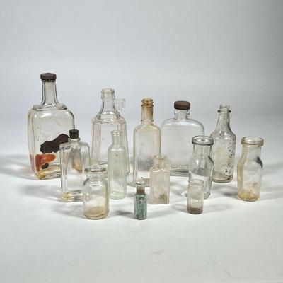 (13pc) MIXED ANTIQUE & OTHER CLEAR GLASS BOTTLES | Mixed lot of antique and other clear glass bottles, including apothecary...