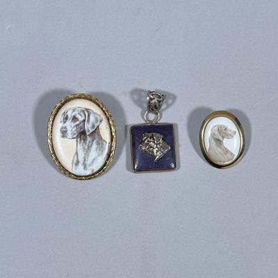 (3pc) DOG PENDANTS & BROOCHES | Including carved stone pendant with mixed metal relief, and 2 painted ceramic dog pendants/brooches....