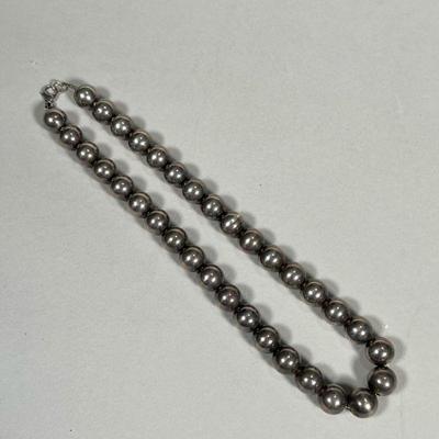 STERLING BEADED NECKLACE | Sterling silver beaded necklace on a silver chain, marked 925 on the clasp, beads tested to silver; 1.7 ozt -...