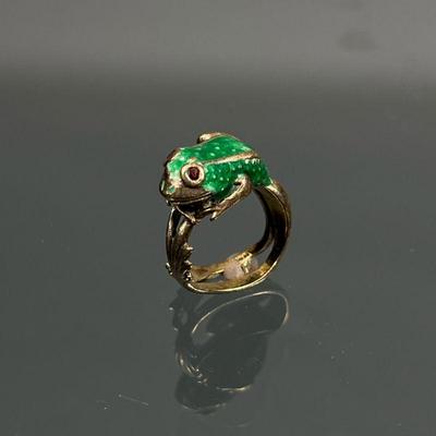 14k GOLD & ENAMEL FROG RING | Designed as a green enameled frog with faceted stone eyes, the legs extending into the band; with...