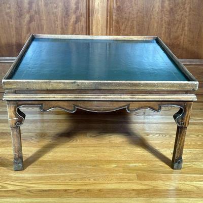 LEATHER TOP COFFEE TABLE | Green leather top with embossed gilt border and carved legs. - h. 19.25 x w. 34 x l. 34 in

