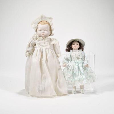 (2pc) PAIR ANTIQUE CERAMIC DOLLS | Includes: baby doll with ceramic head hands and feet, and small ceramic child in blue dress. - h. 10 x...
