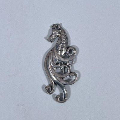 STERLING SILVER HORSE BROOCH | Designed as a Sterling silver horse/seashorse brooch/pin, marked on back “Sterling”; 17.9g - w. 1.5 x l....