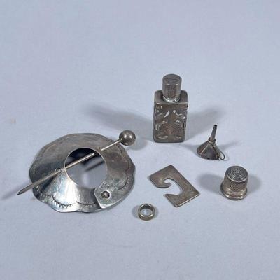 MIXED STERLING SILVER | Including: Sterling silver penannular brooch (20.2g), Sterling silver thimble marked “Sterling” (3g), miniature...