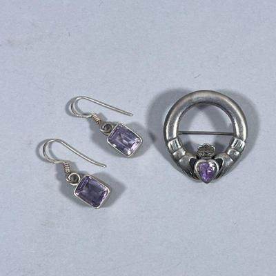 STERLING SILVER JEWELRY | Including a sterling silver Claddagh brooch with Celtic design of 2 hands holding a faceted purple stone,...