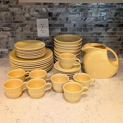 Lot #29 - Vintage Fiesta Dinnerware Collection - Pale Yellow Plates, Bowls, Cups, and Serving Pitcher
