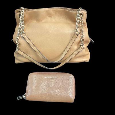 KAAR548 Michael Kors Purse And Wallet	Tan pebbled Saffiano leather. Small mark on back of wallet and one corner on bottom of bag shows a...