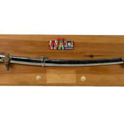 WATA214 American Military Sword	Military sword on a wooden display. Blade isn't sharp and does have a unknown stamp.
