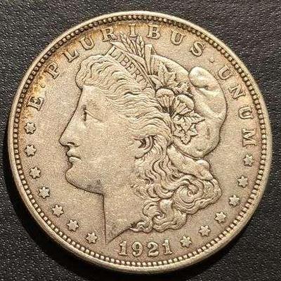 1921 MORGAN SILVER DOLLAR 90% SILVER 26.73 grams (. 859 troy ounces) and is composed of 90% silver and 10% copper- 0.77344 troy ounces of...