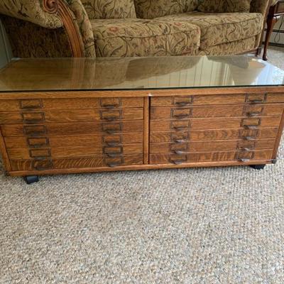 Very nice antique quarter sawn oak filing cabinet/ coffee table . Fitted w/ glass top and wheels
