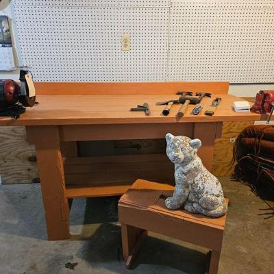 Workshop table, bench and concrete statue