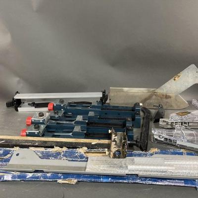 Lot 411 | Bosch TS1002 & Table Saw Attachments Dewalt
