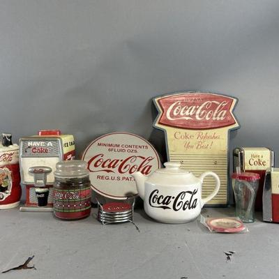 Lot 324 | Coca-Cola Cookie Jars, Signs, Coasters, & More
