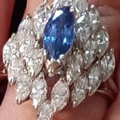 Ladies vintage diamond and sapphire ring. 7.2 grams of 18kt white gold with 3/4 carot natural blue marquise cut sapphire. 22 natural...