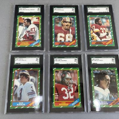 Lot 148 | 6 1986 Mint Graded Topps Football Cards
