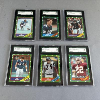 Lot 145 | 6 1986 Mint Graded Topps Football Cards
