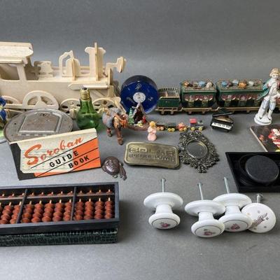 Lot 624 | Trinkets, Bank, Belt Buckle, Abacus & More
