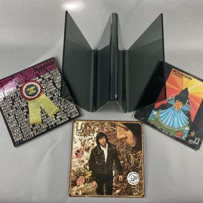 Lot 485 | Vintage Wavey Acrylic Record Stand & 3 Records
