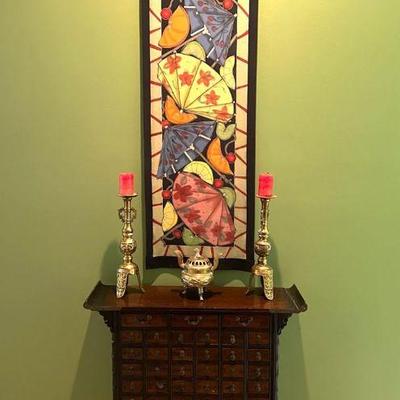 Antique Asian medicine cabinet with silk tapestry signed by Schorr and brass candlesticks 