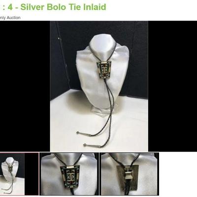 Lot # : 4 - Silver Bolo Tie Inlaid
Signed on back, hand made with woven cord with silver tips. 38.9 grams of tested silver.
