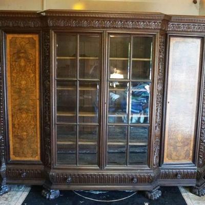 1101	ANTIQUE OAK CARVED GERMAN CABINET HAVING 2 BURLED PANEL DOORS, 3 INDIVIDUAL PANED GLASS CENTER DOORS OVER 3 DRAWERS, FULL FIGURE...