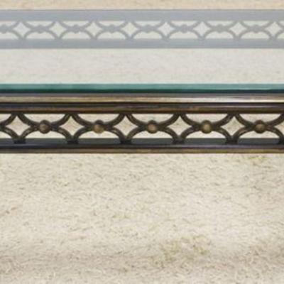 1141	COCKTAIL TABLE W/PIERCED WOOD BASE IN AN EBONIZED & GOLD WASH FINISH, BEVELED GLASS TOP, APPROXIMATELY 61 IN X 33 IN X 18 IN HIGH
