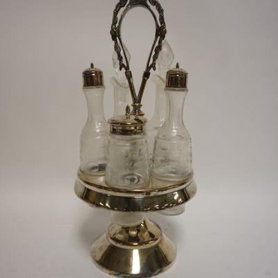 1098	ANTIQUE CASTER SET IN SILVERPLATE HOLDER W/5 WHEEL CUT BOTTLES, APROXIMATELY 14 1/4 IN HIGH
